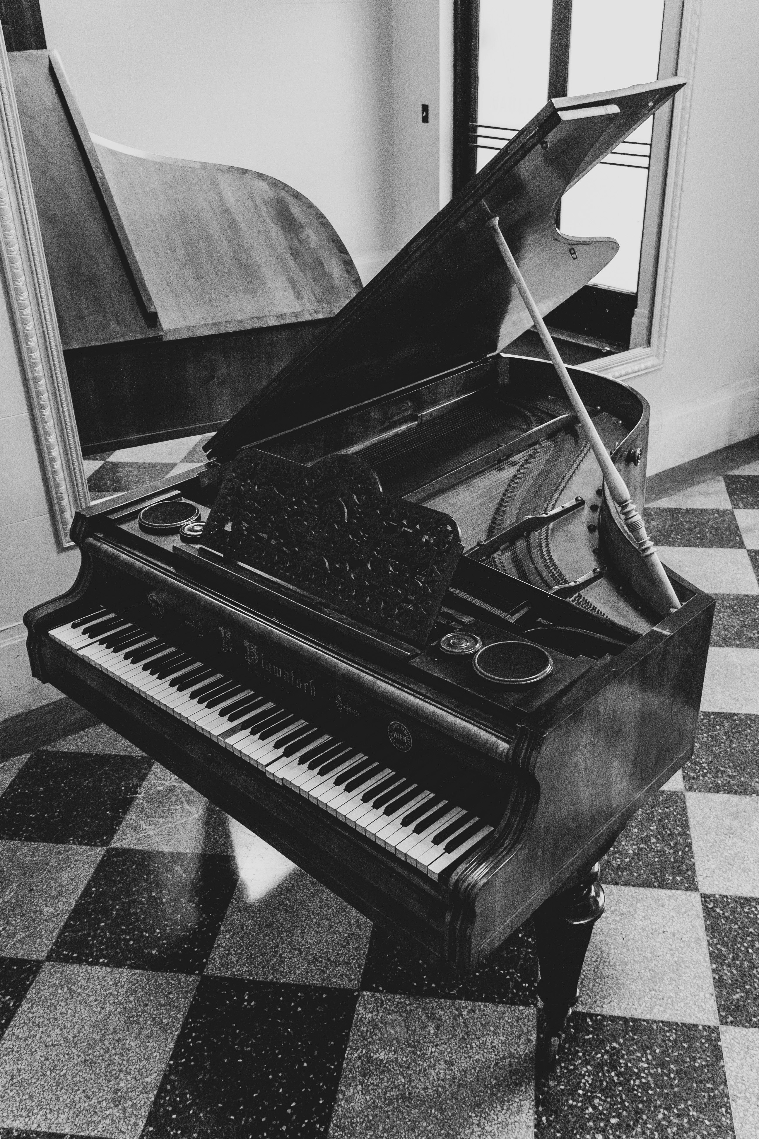 greyscale photo of grand piano